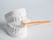 Oral hygiene health concept close up orange toothbrush in dental gypsum model plaster