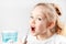 Oral irrigator. Child girl brushes her teeth. Prevention of caries