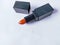 Oral or orange brick color lipstick  on background white