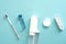 Oral water irrigator, toothbrush, liquid, flosser on blue background. Flat lay, top view, overhead