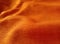 Orange abstract background bumps of corrugated cotton fabric