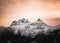 Orange alpen glow behind Sky Pilot Mountain in British Columbia