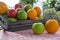 Orange and apple in a wooden crate. Fresh fruit on a wooden table with a cloth. Eating fruit helps to lose weight. fruits and
