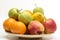 Orange, apples and banana on the wooden plate