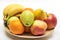 Orange, apples and banana on the wooden plate