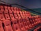 Orange, art deco fuzzy movie theater seats in an empty theater