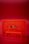 Orange audio cassette on the dark red background