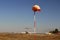 Orange aviation windsock blowing in the wind