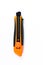 Orange and back paper knife or cutter on white background