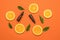 Orange background with orange slices, green leaves and bottles with pipettes