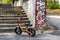 Orange balance bike near stone stairs