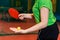 Orange ball for table tennis lies in the palm of a young athlete. the beginning of the game ping pong close