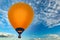 Orange balloon against the blue sky