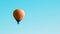 Orange balloon soars against the blue sky