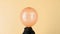 Orange balloon with the word Boo inflates on yellow background.