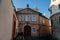 Orange Baroque Canonical house or Kanovnicky dum at Hradcany Square nearby Prague Castle, sunny winter day, Prague, Czech Republic