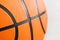 Orange basketball ball close up. Fragment, black stripes, texture. Sport geometric background