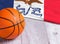 Orange basketball ball with flag Iowa on wooden parquet. Close-up image of basketball ball over floor in the gym. Basketball