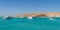 Orange Bay Beach with crystal clear azure water and boat ships with tourists