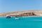 Orange Bay Beach with crystal clear azure water and boat ships with tourists