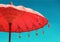 Orange beach umbrella umbrella on sky background, vintage retro