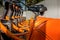 Orange bicycles lined up on pavement in the city. Bike urban transport. Detail of wheels at bycicle sharing point