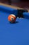 Orange billiard ball in a pool table