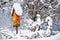 Orange birdhouse covered with snow