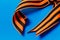 Orange black George ribbon on a blue background