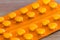 Orange blister pack of small round pills