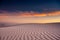 Orange and Blue Skies Over White Sand Dune Lines