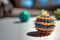 Orange and blue spiked ball with defocused balls in background