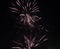 Orange blurred firework lights on black sky background. Concept of New Year and Christmas