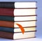 An Orange Bookmark and Leather Bound Books