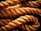 Orange braided nylon rope in tangled coil black background