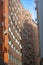 Orange brick building with concave wall, vertical view