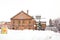 Orange brick building of Suppolo beer factory with heap and thick snow landscape