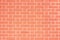 Orange brick wall, light red background of masonry, texture stained blocks of stonework.