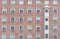 Orange brick wall vintage building. Glass window of skyscraper apartment or hotel building. Exterior brick wall of residential