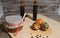 Orange, brown and black chevre cheese with spices on a wooden tray and wooden background