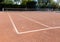 Orange brown sand empty private tennis court ready for game