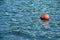 Orange buoy floating on sea