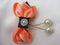 orange butterfly brooch decorated with white pearls