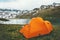 Orange camping tent at lake in mountains landscape