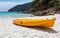 Orange canoe kayak lying on a beach