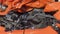 Orange car crash background. Close-up detail of auto wreck. Front side of crashed car from accident. Car accident