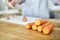 Orange carrot lying on a wooden kitchen table. Food ingredient. Vegetables