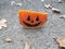Orange cheese with Halloween pumpkin face and asphalt