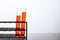 Orange chemicals in a science glass tube arranged on a shelf