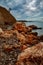 Orange cliffs, and stones in Moon bay, Strunjan